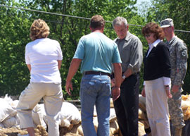 President Bush visits a sandbag levee outside a business in Iowa City.