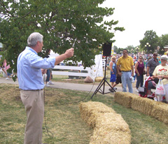 Kim Schmett holds up "Boswell/Obama meter," a tire guage.