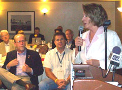 Iowa Congressmen Dave Loebsack and Bruce Braley listen to House Speaker Nancy Pelosi.