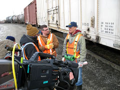 History Channel's Extreme Trains producer/director Dominic Stobart and the show's host Matt Bown (center) get a job briefing from Union Pacific switchman/brakeman Blake Benne in Council Bluffs, Iowa, rail yard. 