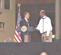 President Obama is greeted at Trinity Towers by Richard Mulbrook.