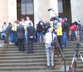 Reporters interview gay couples waiting at the Polk County Administration Building.