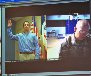 Lieutenant Colonel Hal Turner  (left) swears his son Brett into the military via the internet.