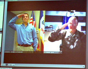 Brett Turner (right) in Johnston and Hal Turner in Iraq salute each other via internet webcams.