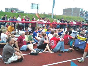 Mourners gathered at Ed Thomas.field in Parkersburg to honor the slain coach.