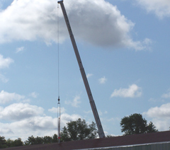 A crane lifts the 40 foot periscope into place.