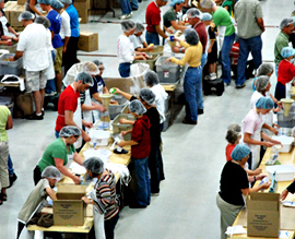 Volunteers pack meals.